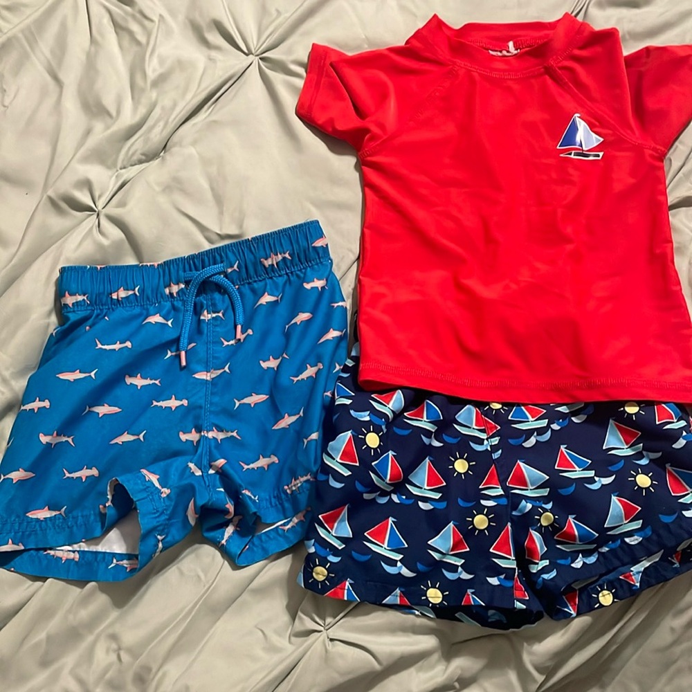 Two pairs of babies, swim trunks, and one swim shirt